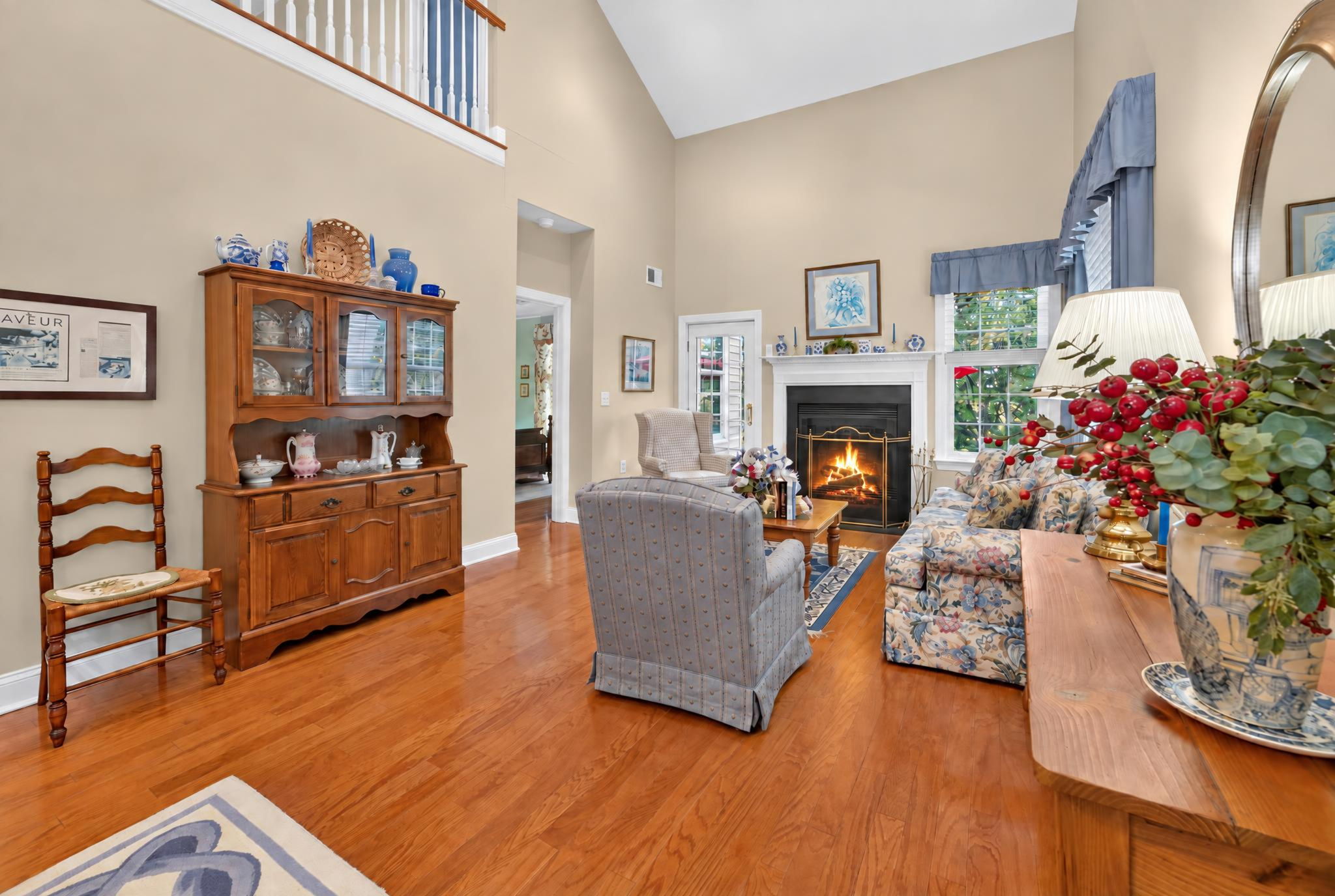 TWO STORY LIVING ROOM The living room features a gas fireplace with a custom mantel.