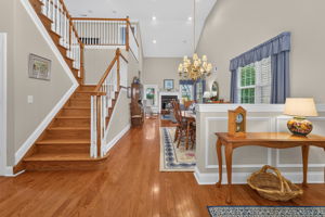 Chair rail and box mouldings enhance the foyer. Rich hardwood flooring extends throughout the main level.