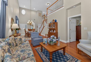 TWO STORY LIVING ROOM The living room features a gas fireplace with a custom mantel