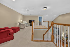 LOFT This versatile space features recessed lighting, crown moulding, a ceiling fan, and carpeting, making it ideal as a family room, home office, or hobby area.