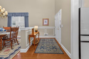 Chair rail and box mouldings enhance the foyer. Rich hardwood flooring extends throughout the main level.