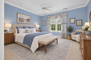 BEDROOM 2 Crown moulding, ceiling fan , double slider closet, and carpeting.