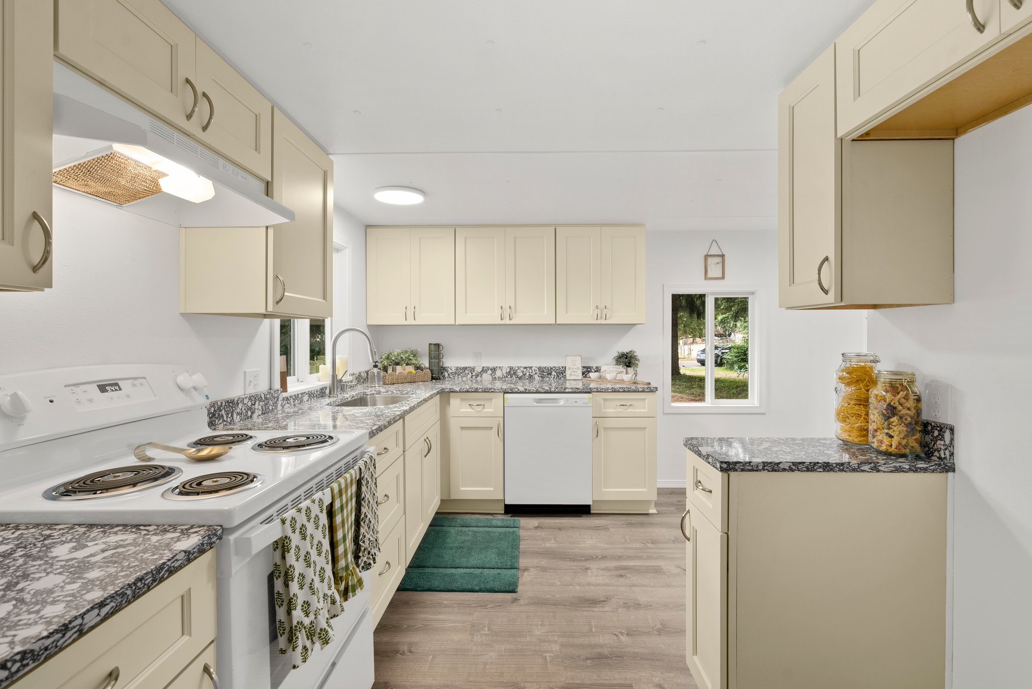 New cabinets and countertops in kitchen.