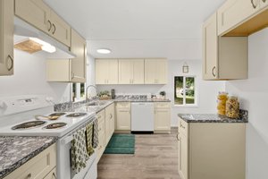 New cabinets and countertops in kitchen.