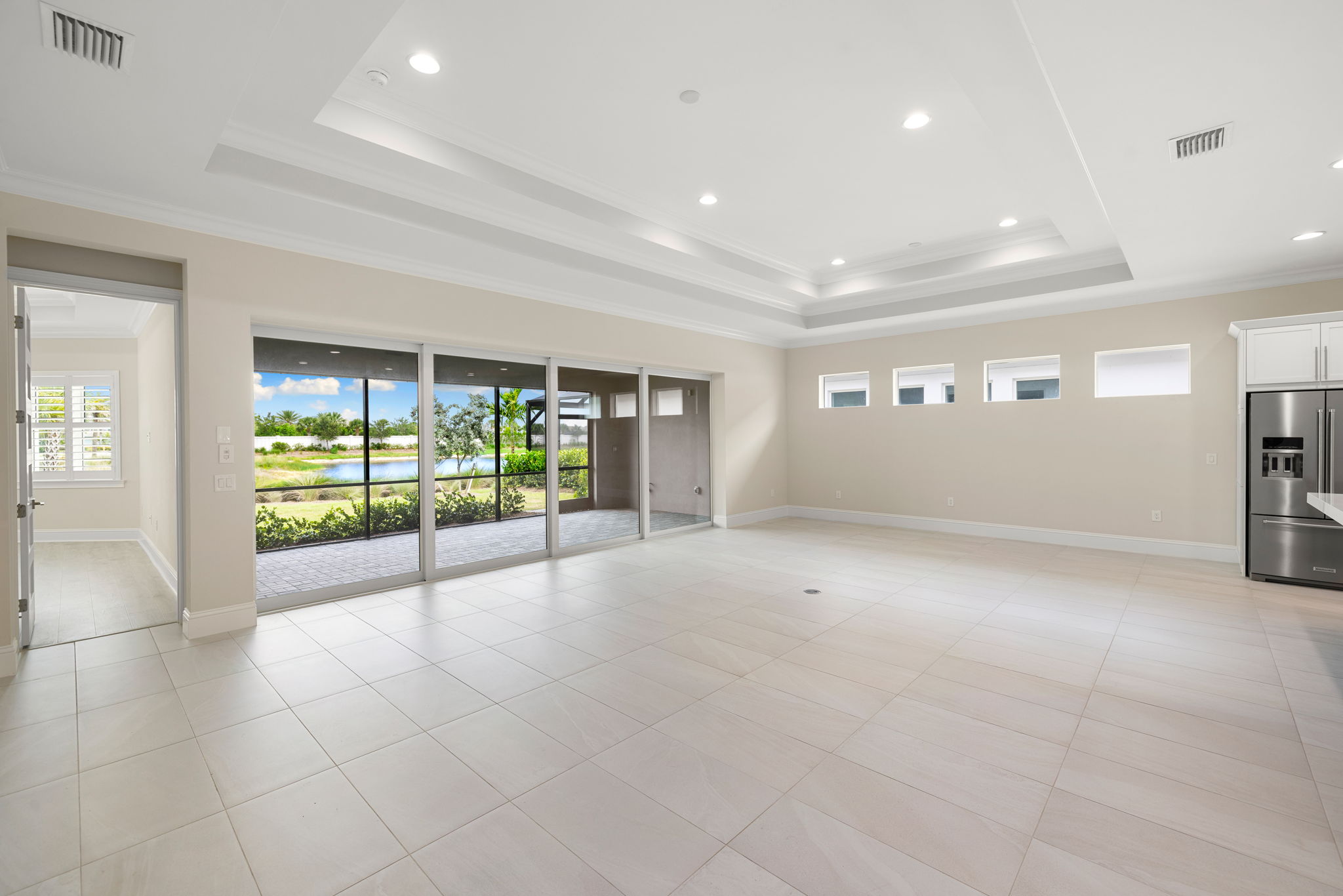 Hurricane impact sliding glass doors disappear into the wall, seamlessly connecting the indoors with the outdoors.