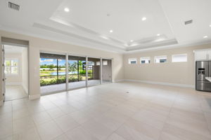 Hurricane impact sliding glass doors disappear into the wall, seamlessly connecting the indoors with the outdoors.