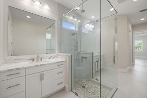 Primary Bathroom features dual vanities & frameless shower
