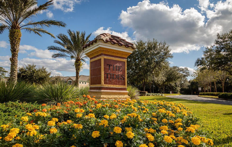 The Tides Sign with Flowers