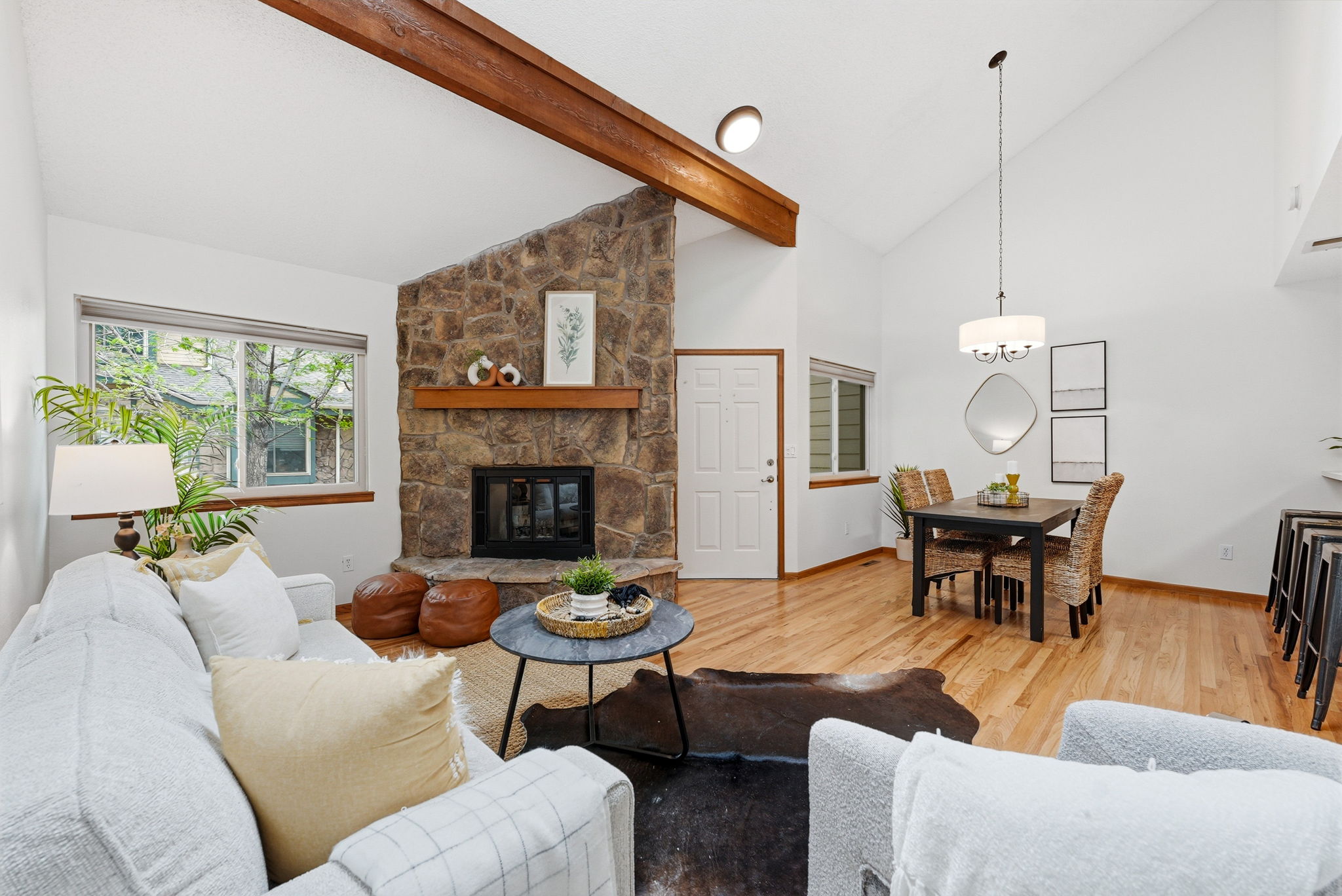 Living Room with Vaulted Ceilings, Exposed Beam, Wood-Burning Fireplace, Real Hardwood Floors, Wood-Burning Fireplace, Dining Room and New Paint Throughout