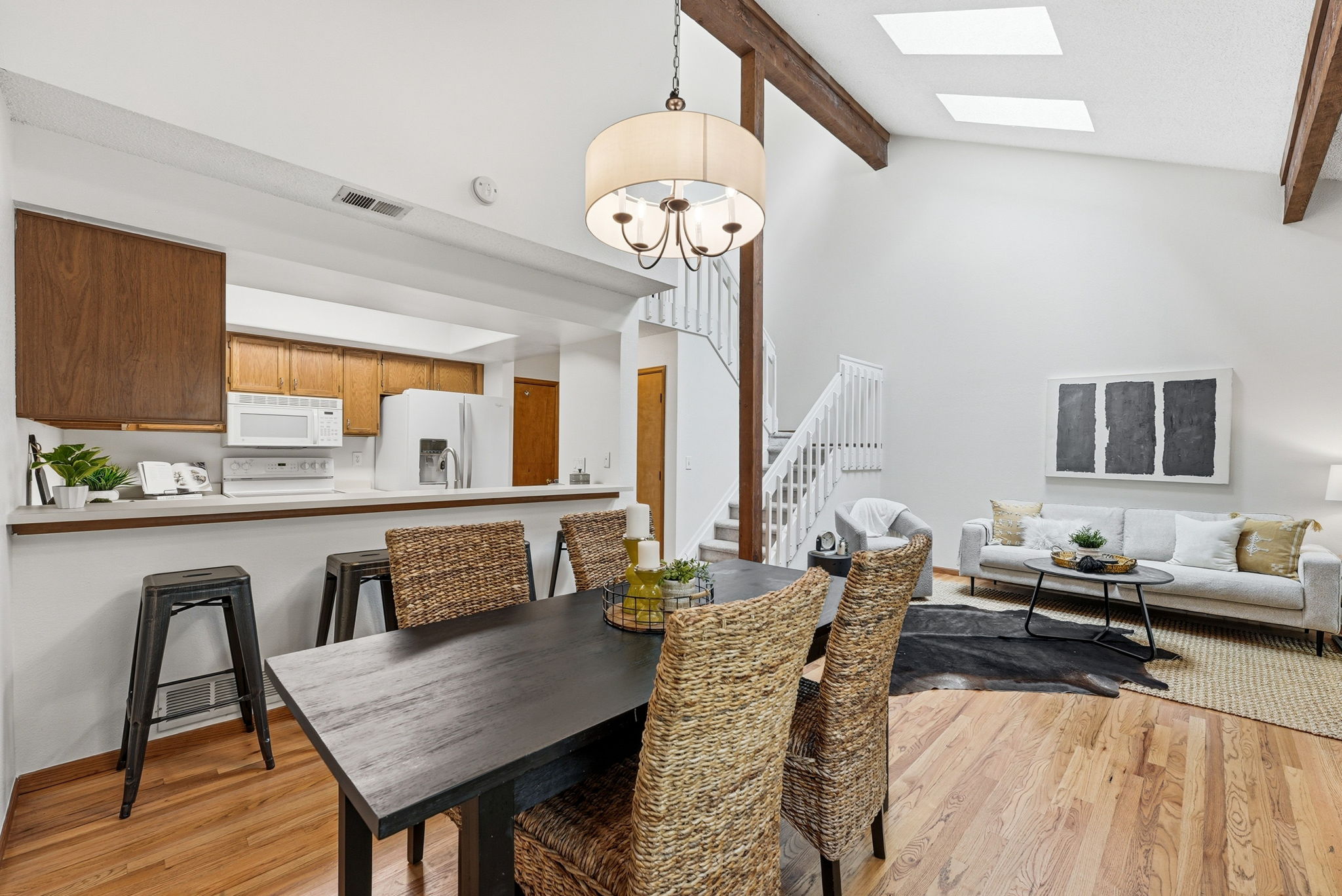Dining Room with Real Hardwood Floors, Kitchen with Bar Seating (All Kitchen Appliances Included), Living Room with Exposed Beam and New Paint Throughout