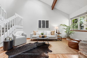 Living Room with Vaulted Ceilings, Exposed Beam, Wood-Burning Fireplace, Real Hardwood Floors, Wood-Burning Fireplace and New Paint Throughout