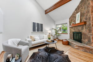 Living Room with Vaulted Ceilings, Exposed Beam, Wood-Burning Fireplace, Real Hardwood Floors, Wood-Burning Fireplace and New Paint Throughout