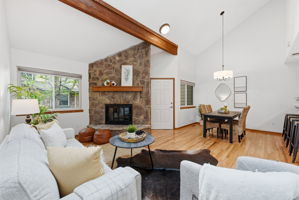 Living Room with Vaulted Ceilings, Exposed Beam, Wood-Burning Fireplace, Real Hardwood Floors, Wood-Burning Fireplace, Dining Room and New Paint Throughout