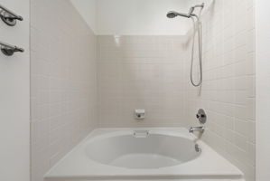 Primary Bathroom with Tile Floors and New Paint (Note: Tub is Oval and Larger than It Appears in Photo)
