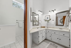 Primary Bathroom with Dual Vanities, Tile Floors, Lots of Counter Space and New Paint