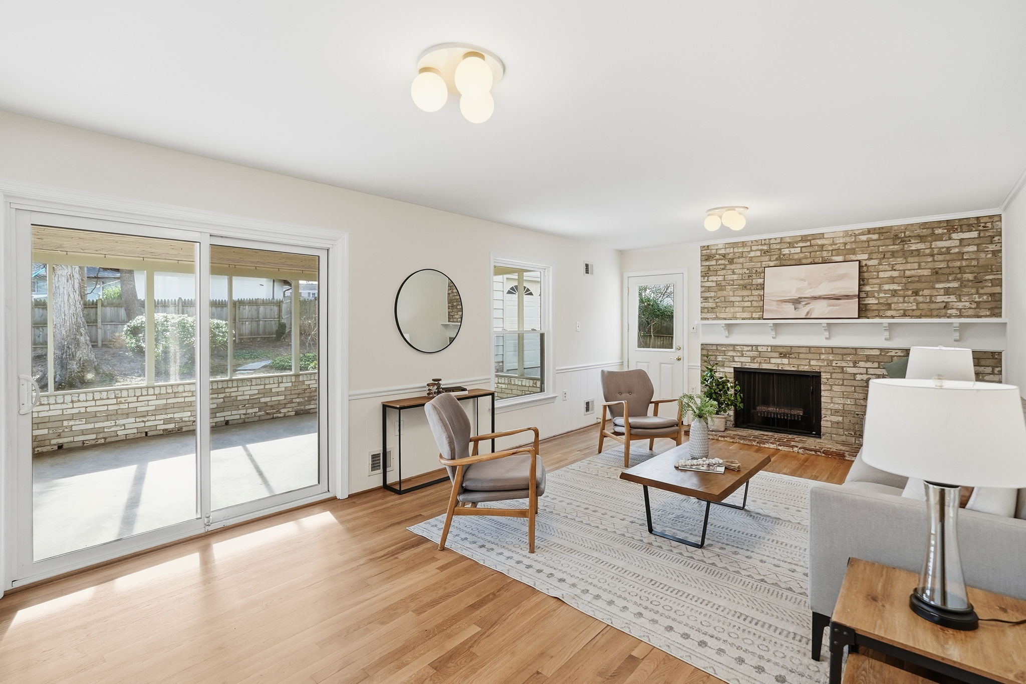Family Room with Wood Burning Fireplace and access to Screened Porch