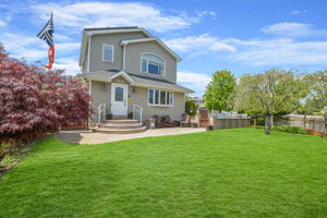 Front view with manicured yard