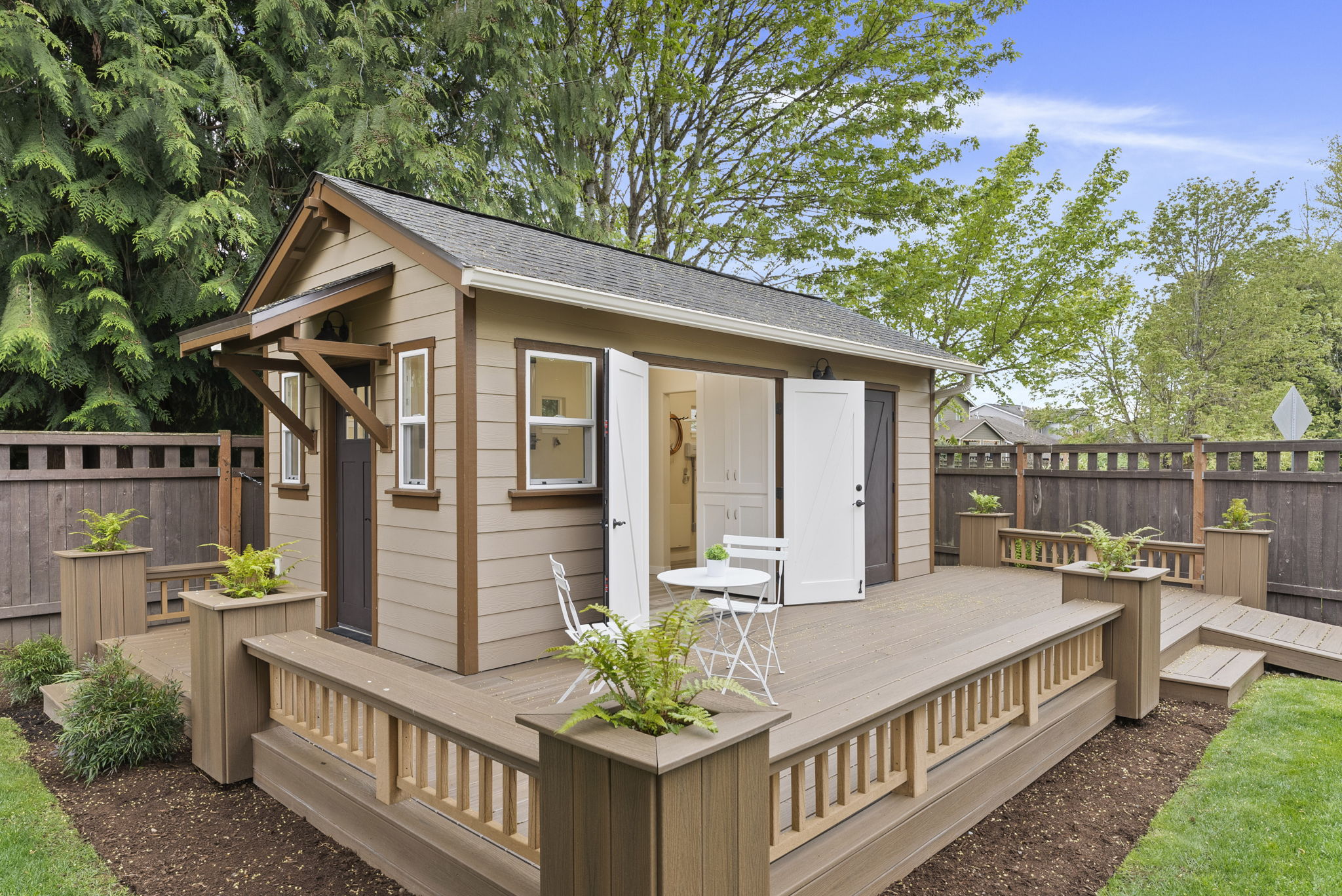Shop deck features custom planters, adding charm and curb appeal