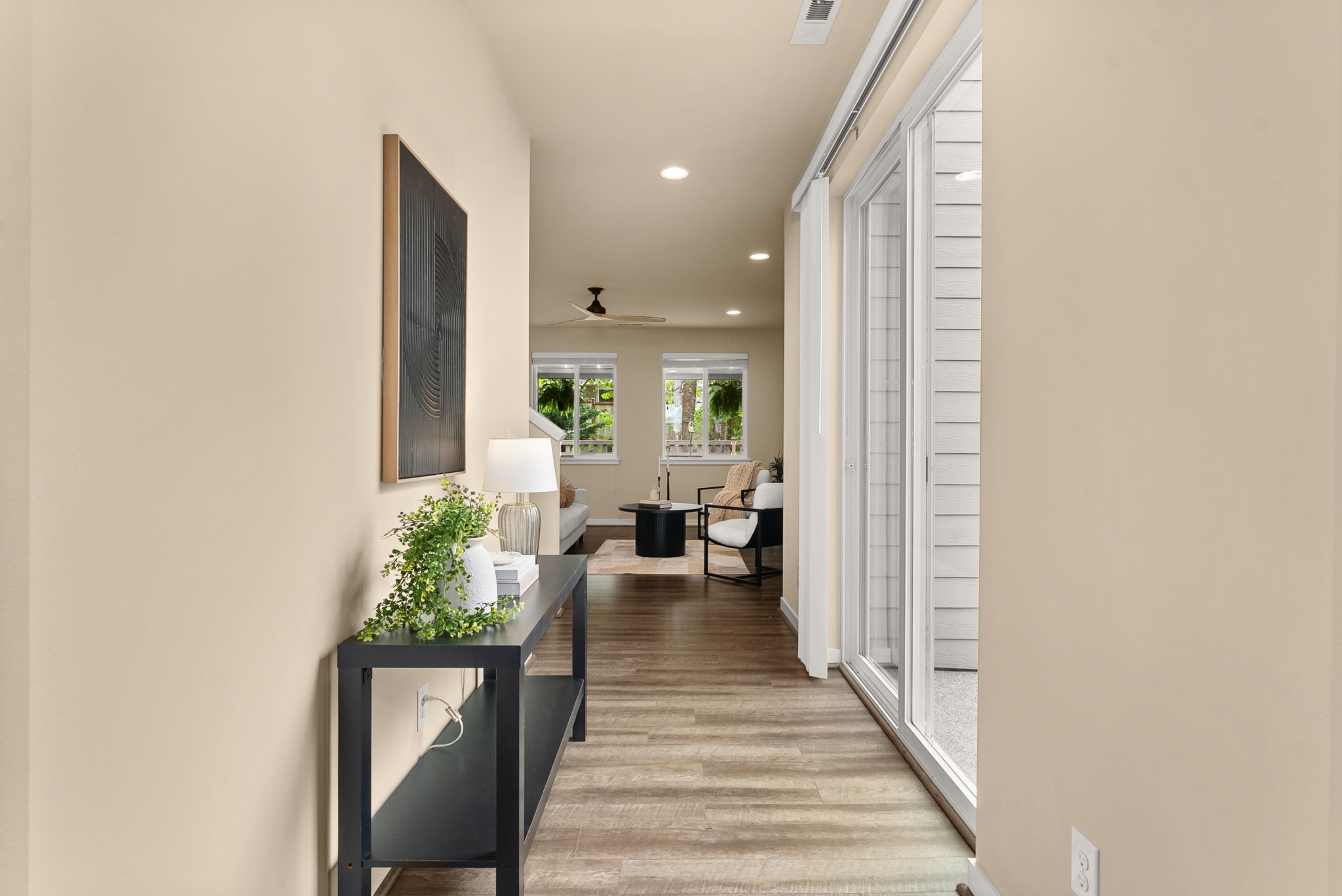 Bright entryway with sliding glass door leading to the backyard, filling the space with natural light