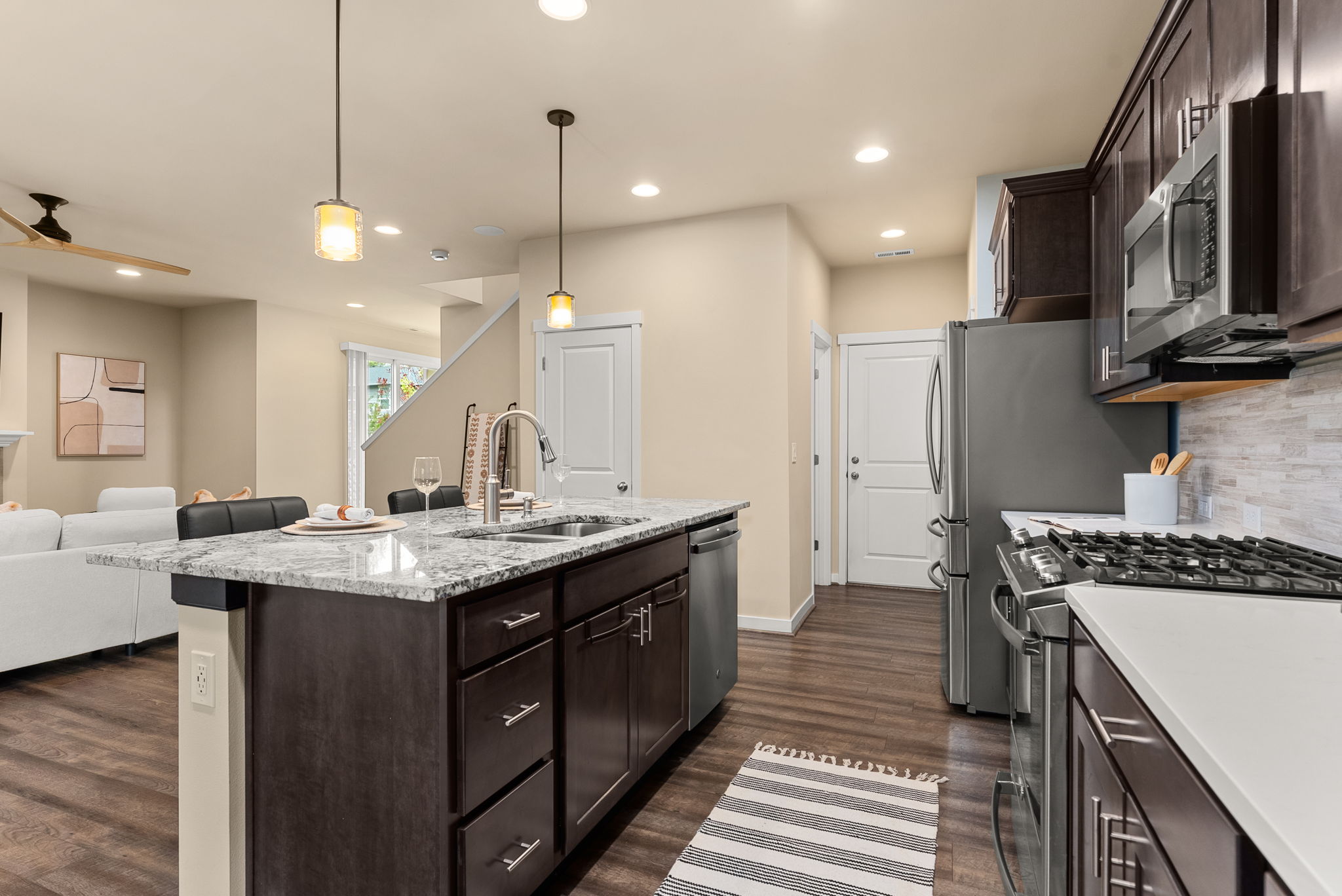 Enhanced kitchen with upgraded countertops, elegant cabinetry, and natural gas stove