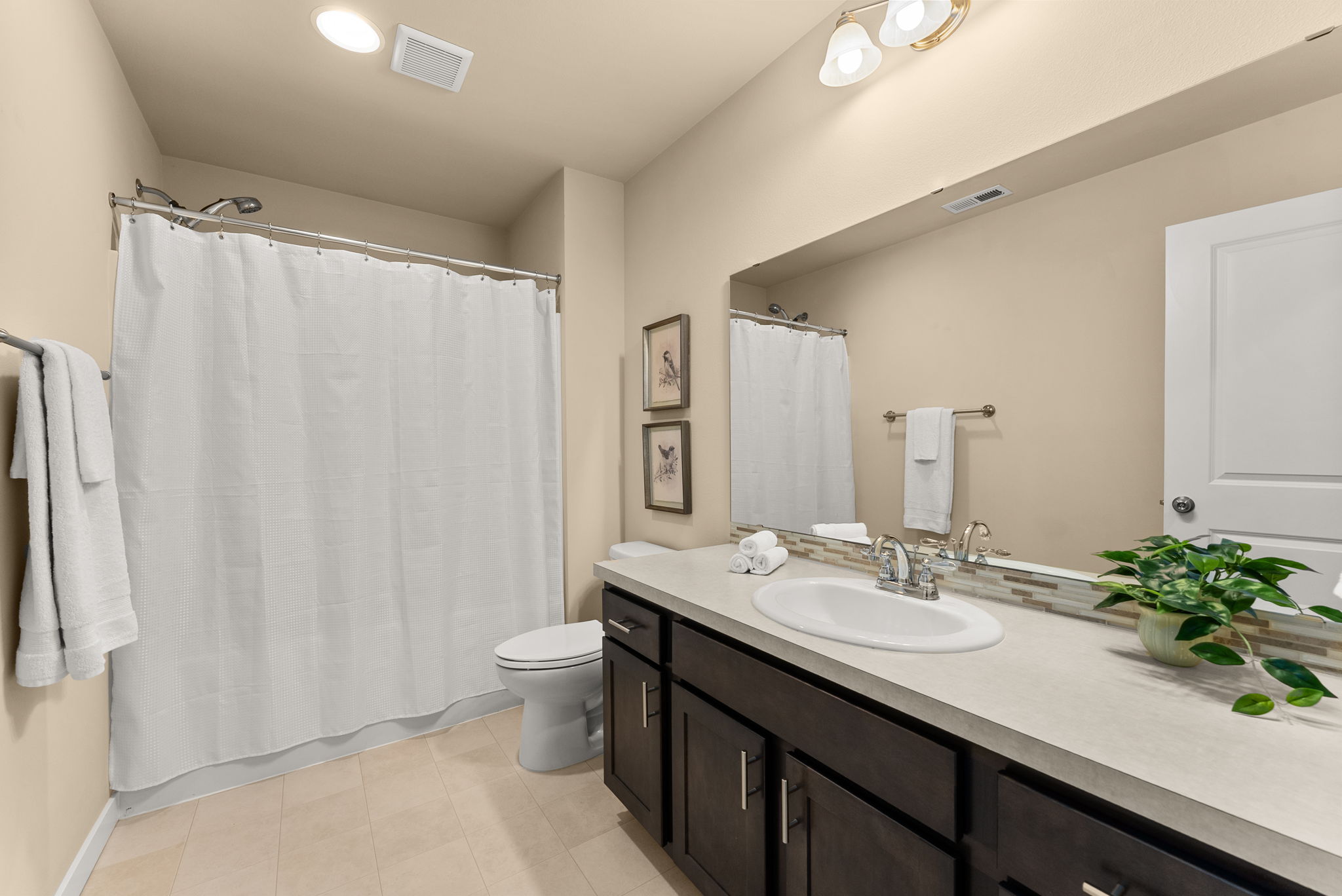 Generously sized guest bath designed for comfort and functionality