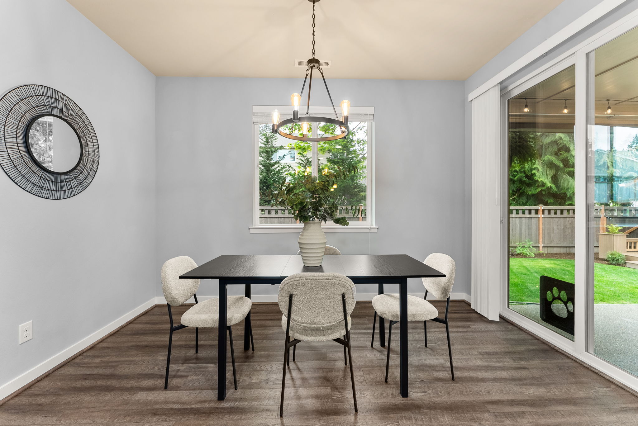 Generous dining area with ample natural light and scenic backyard views