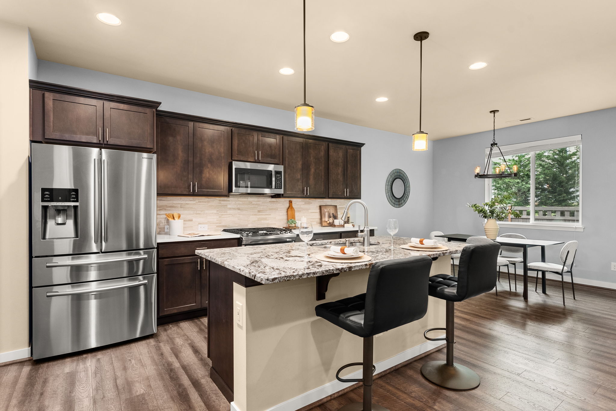 Beautiful kitchen featuring an eat-in bar and under-cabinet lighting for added ambiance