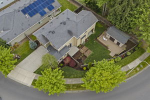 Aerial view capturing the home, custom shop, and lush, well-maintained landscaping