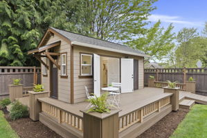 Shop deck features custom planters, adding charm and curb appeal