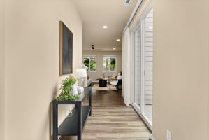 Bright entryway with sliding glass door leading to the backyard, filling the space with natural light