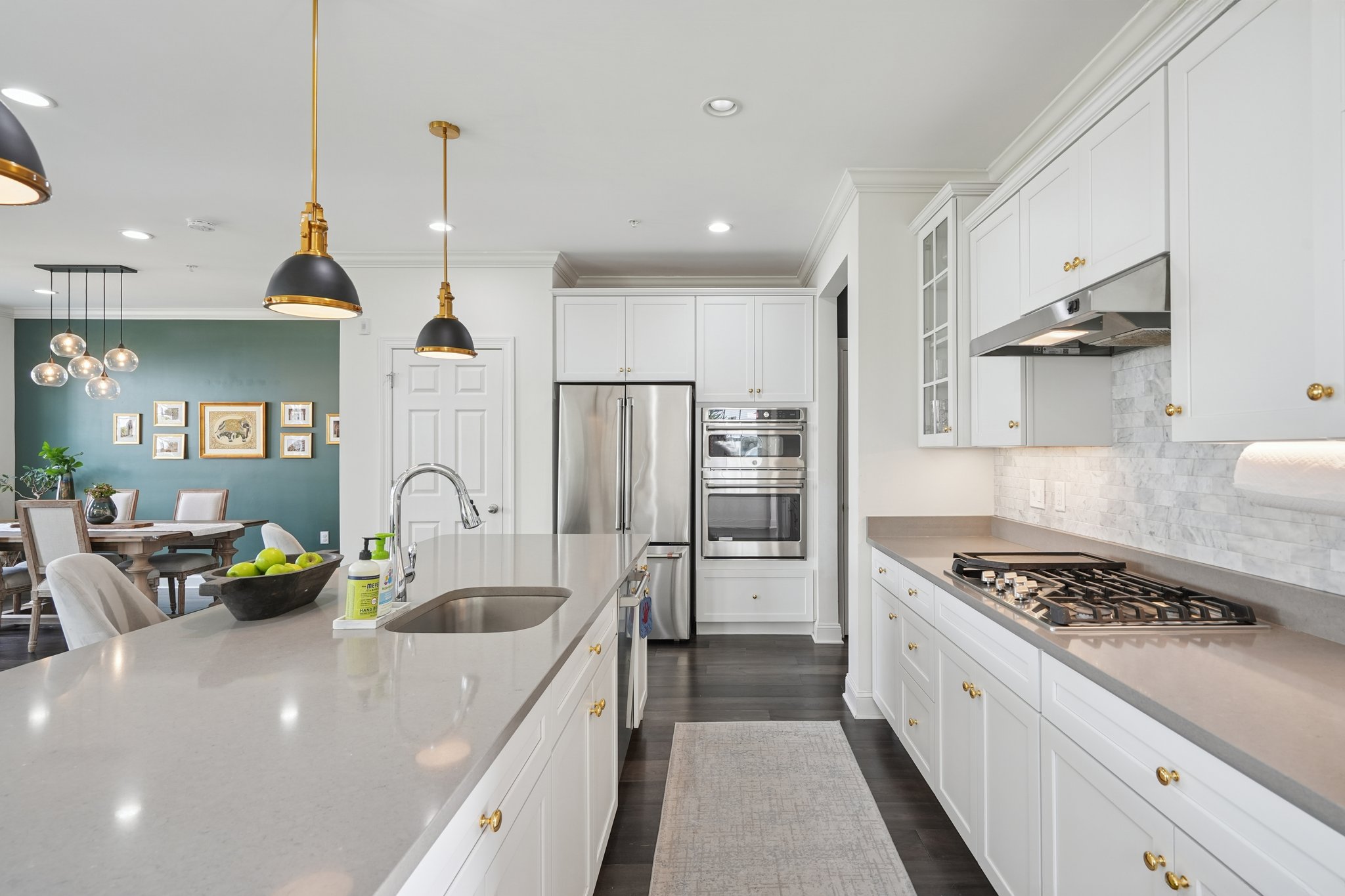 A kitchen built for gathering. An oversized island invites helpers at mealtime and guests to linger long after dinner is served.