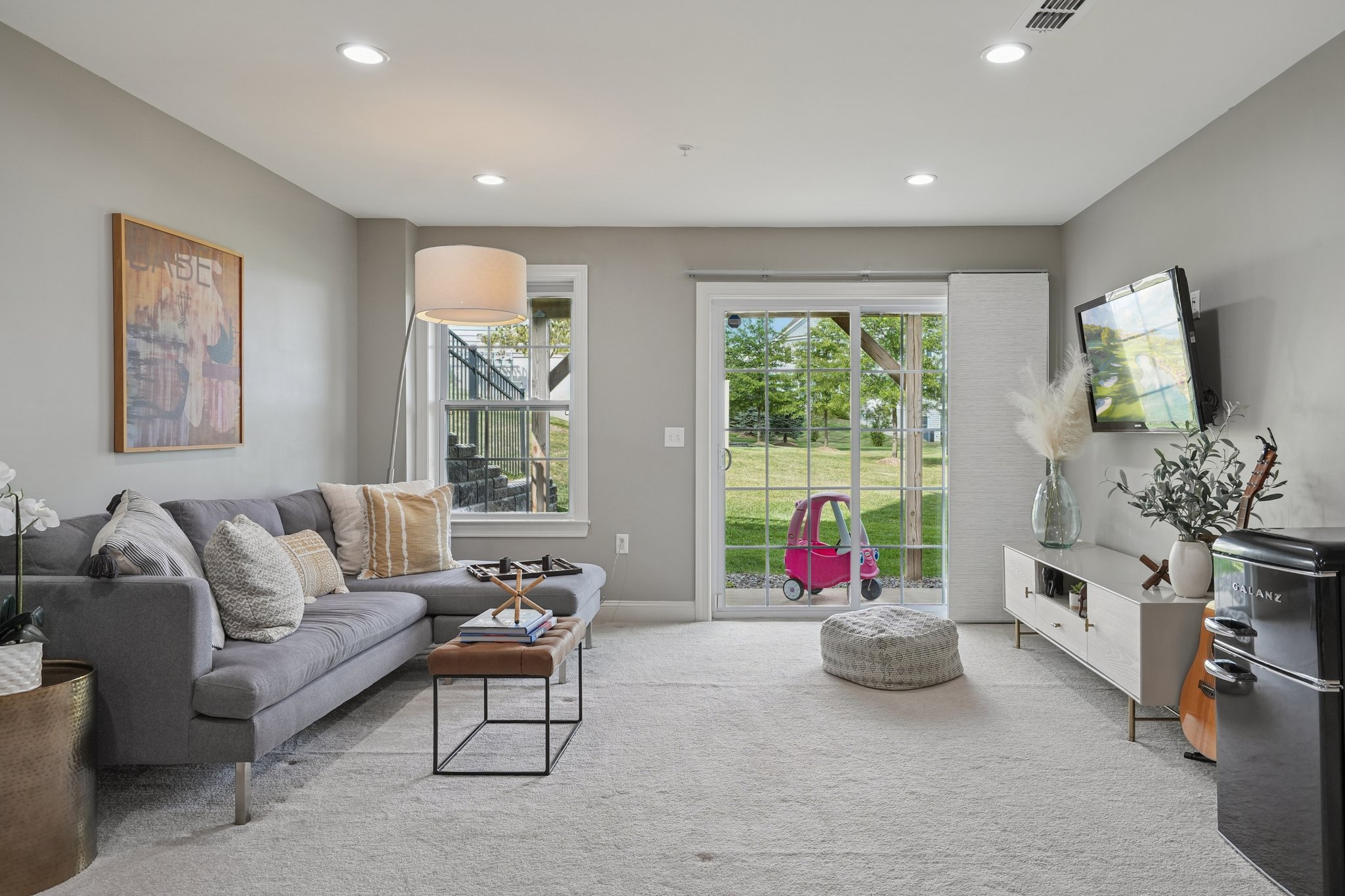A lower level with endless purpose! Sliders open to the patio extending living space and offering a private escape.