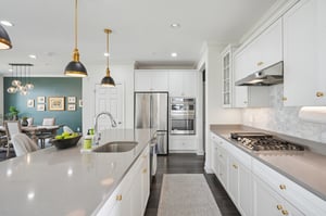 A kitchen built for gathering. An oversized island invites helpers at mealtime and guests to linger long after dinner is served.