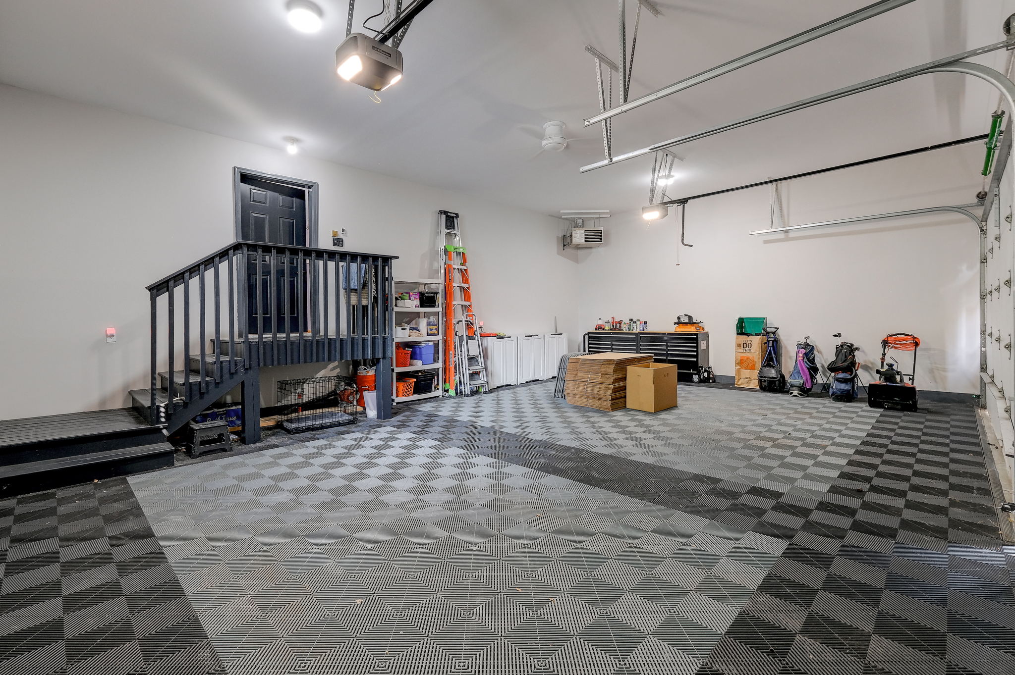 Maintence free flooring in 3 car heated garage.  Brand new insulated garage doors