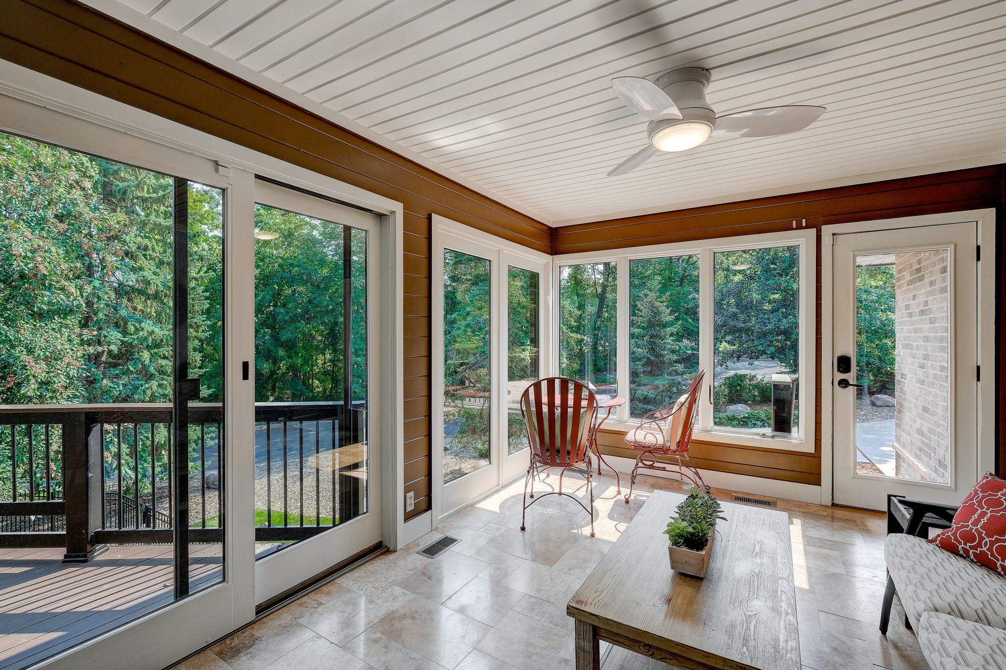 Sun room off informal dining can lead to the deck or driveway.