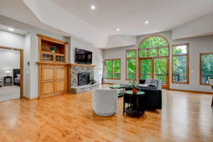 Main floor Great Room features wood floors, fireplace and walk out to maintenance free deckk