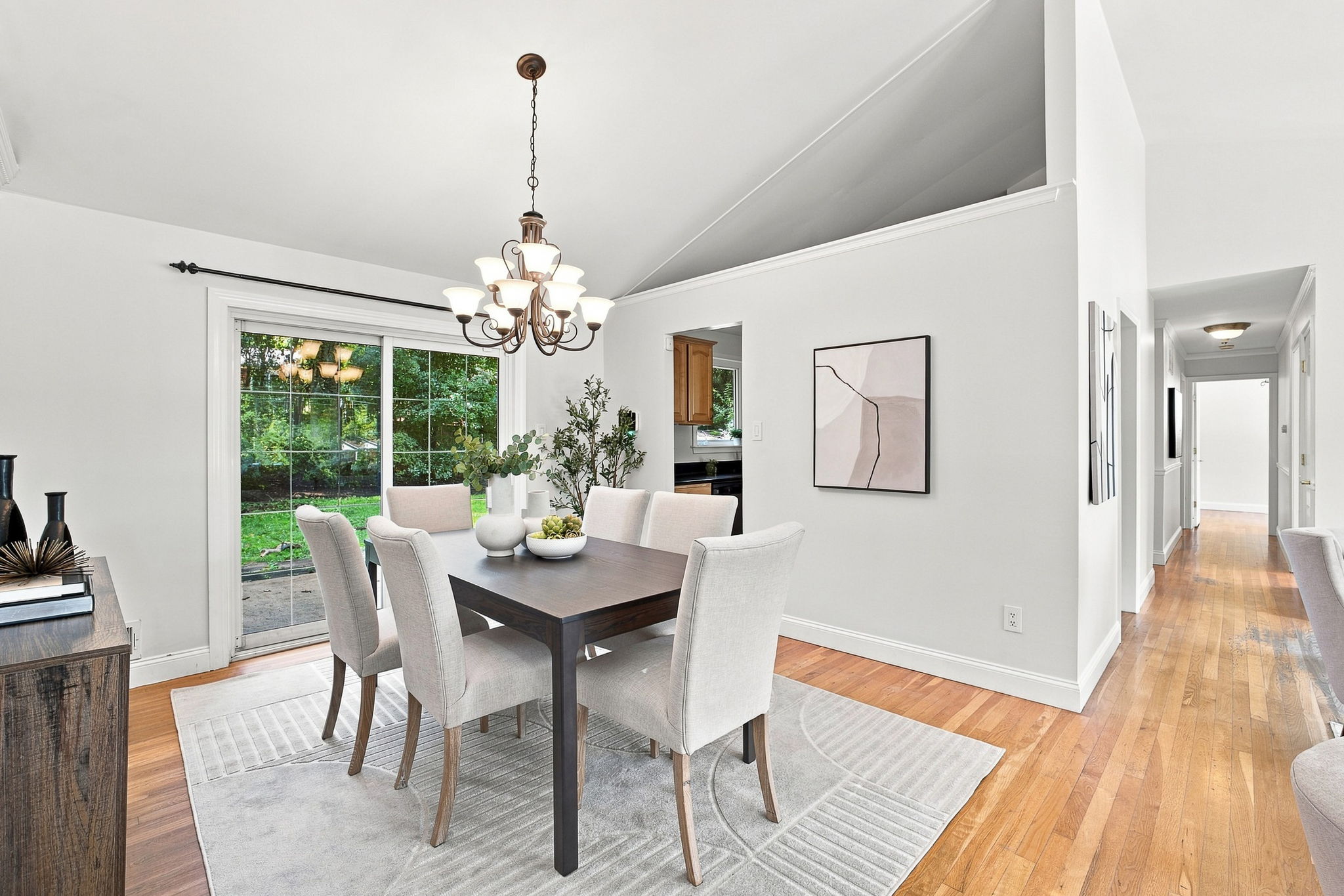 Dining room with vaulted ceiling opens to back patio