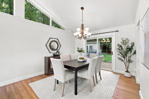 Dining room with vaulted ceiling opens to back patio