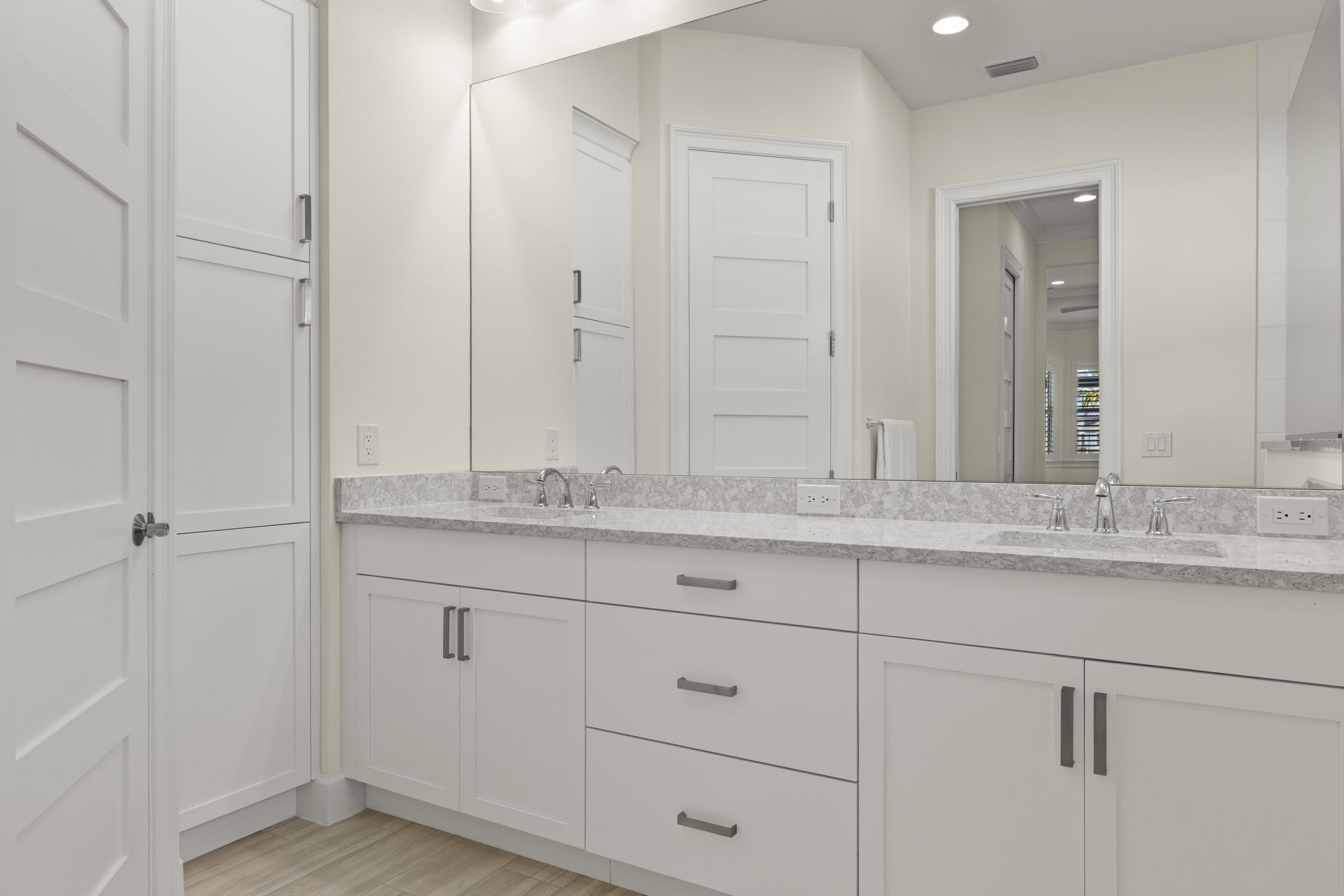 Primary Bathroom featuring white cabinetry, linen closet & water closet