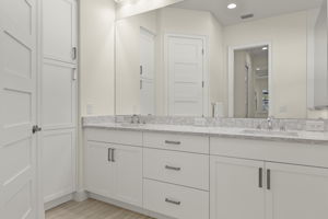 Primary Bathroom featuring white cabinetry, linen closet & water closet