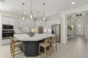 Kitchen with expansive island and walk-in pantry. Soft close, shaker cabinetry, stainless appliances.