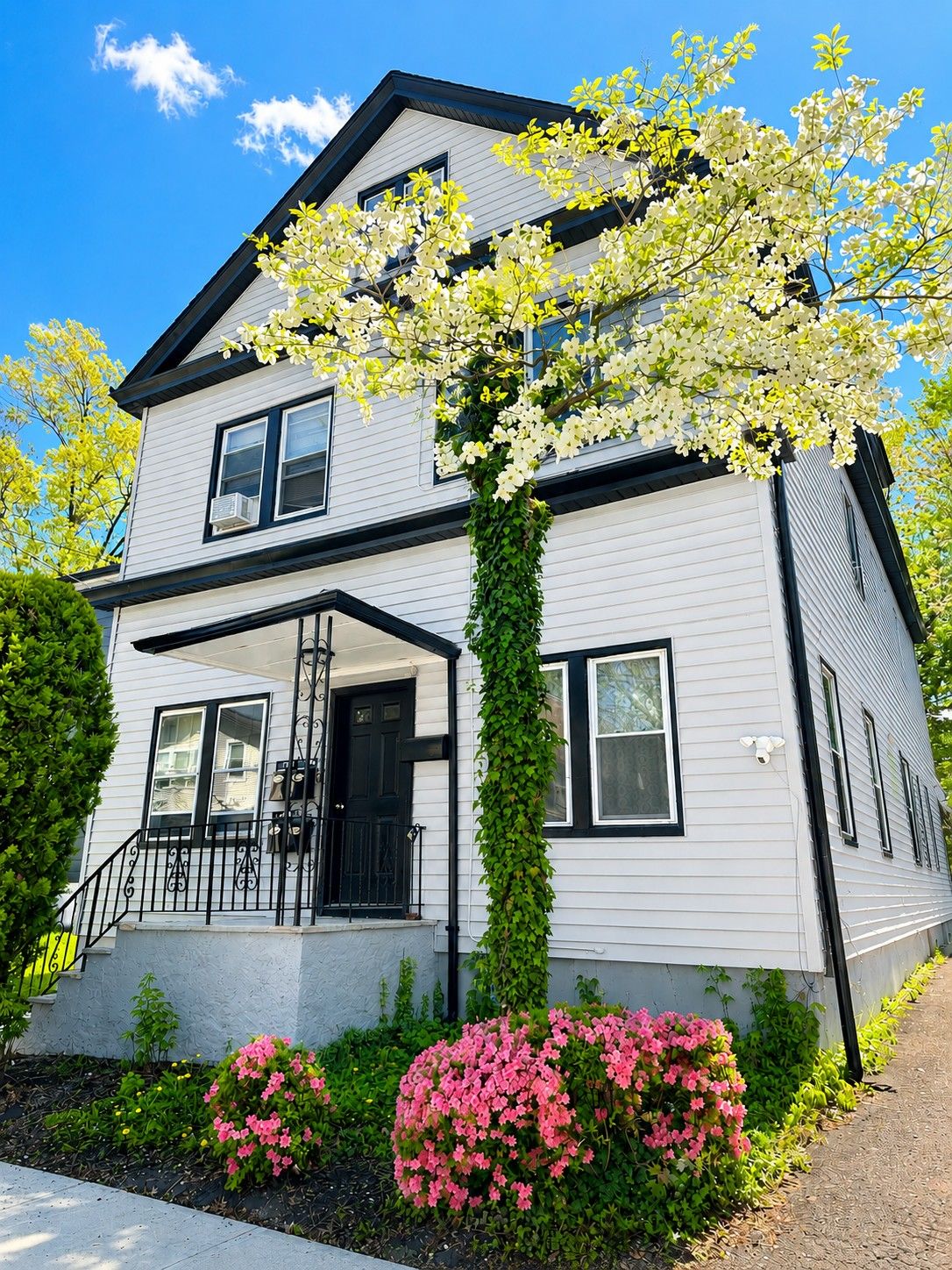 Front with azalea and tree in bloom