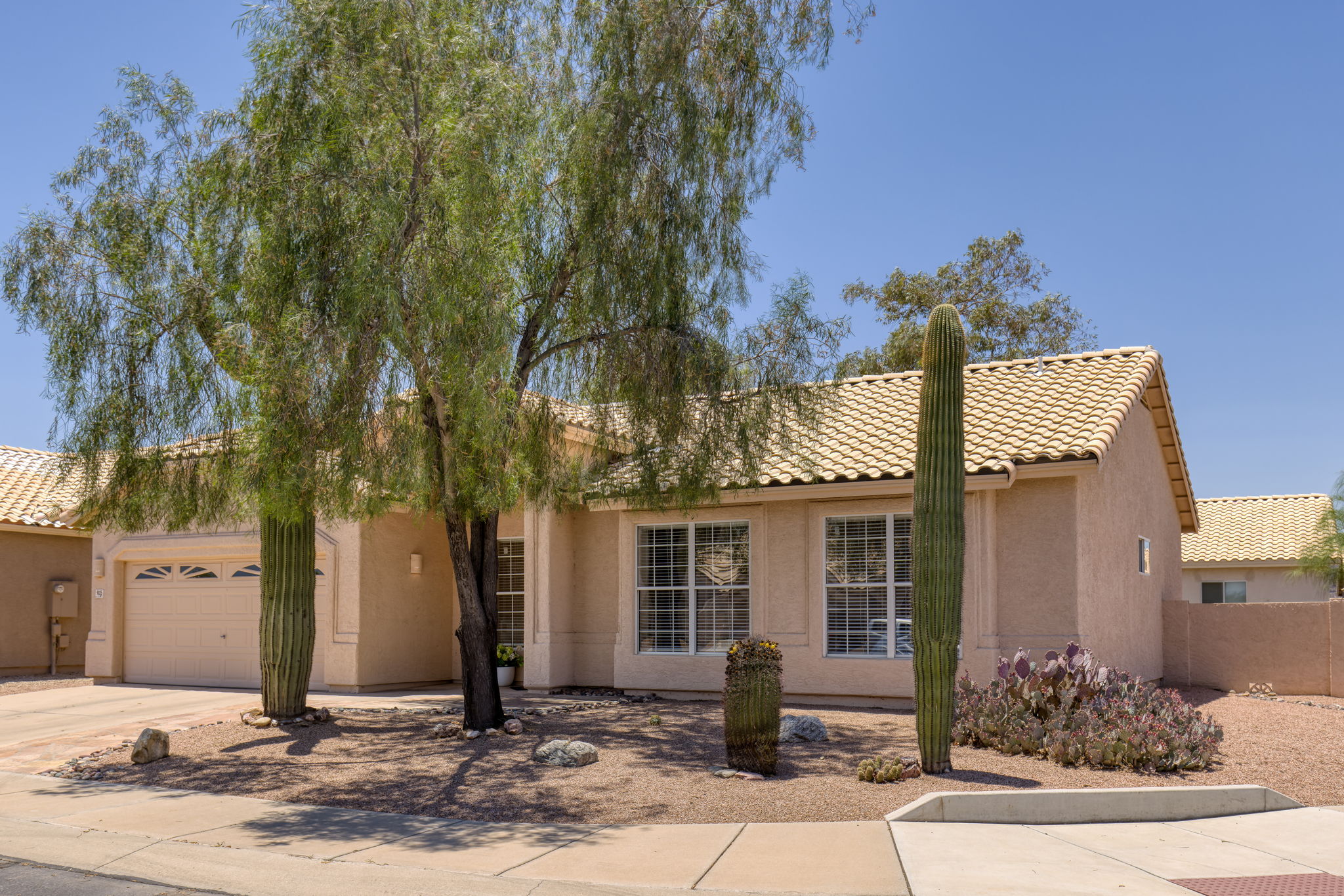 Located on a spacious corner lot with two saguaros.