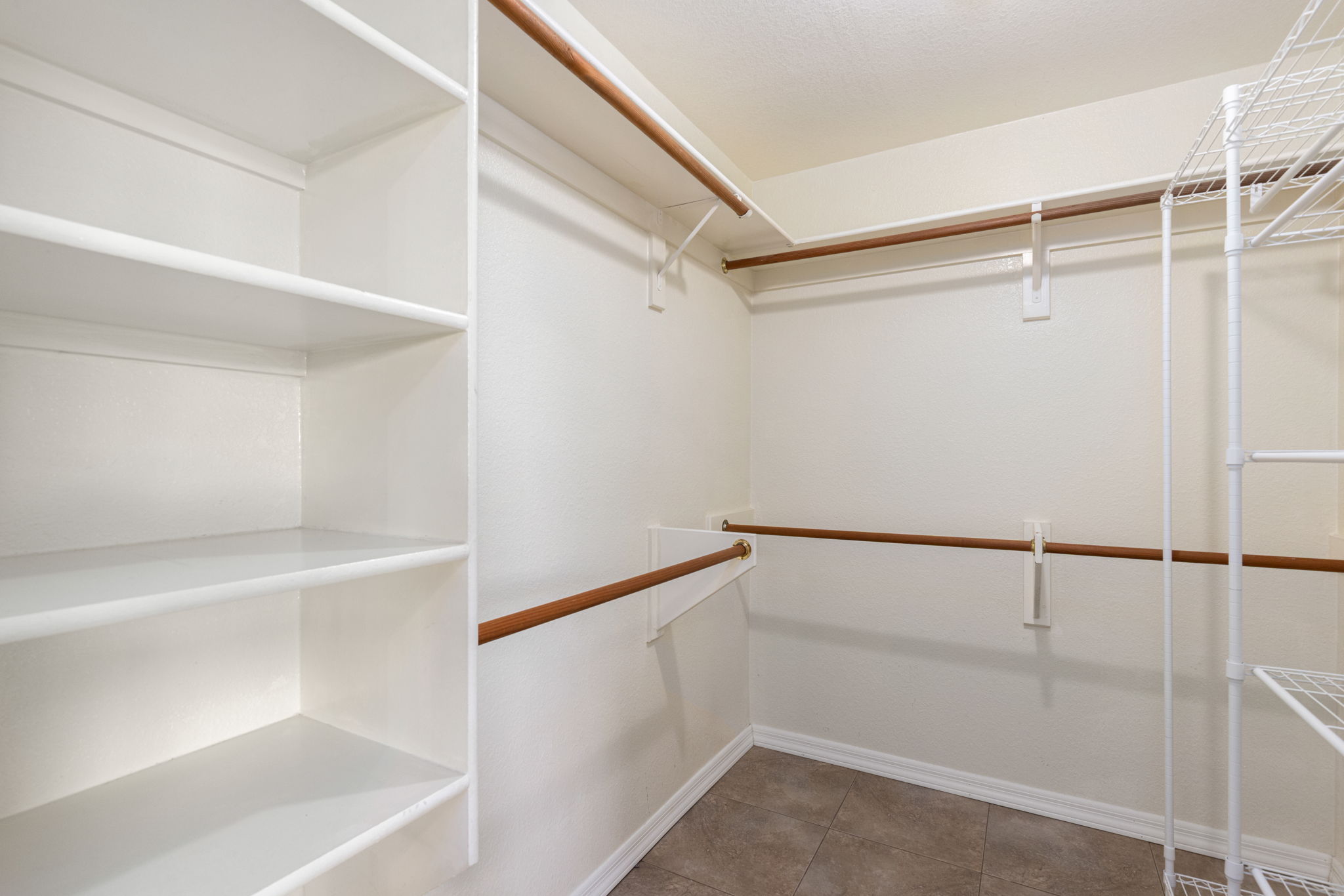 Walk in closet with built in shelves and hanging space.