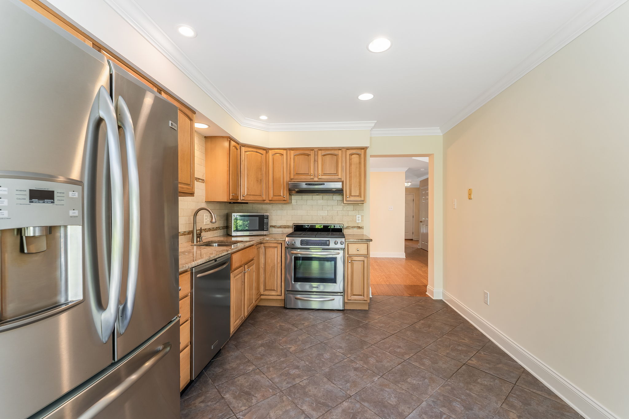 Breakfast nook sliders lead to a private fenced patio and a peaceful wooded backdrop,ideal for relaxing or entertaining.