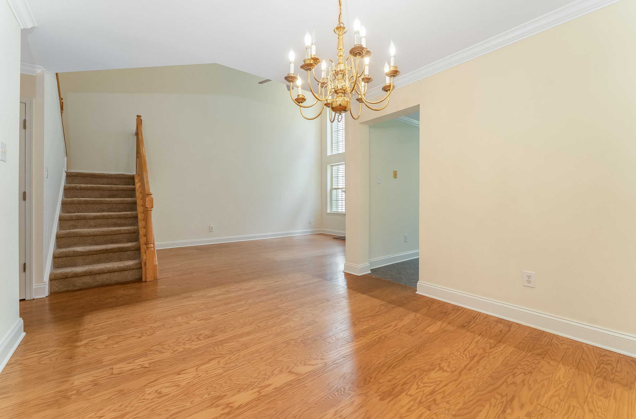 Hardwood flooring flows from the foyer into the dramatic two-story great room and formal dining room, highlighted by crown moulding.