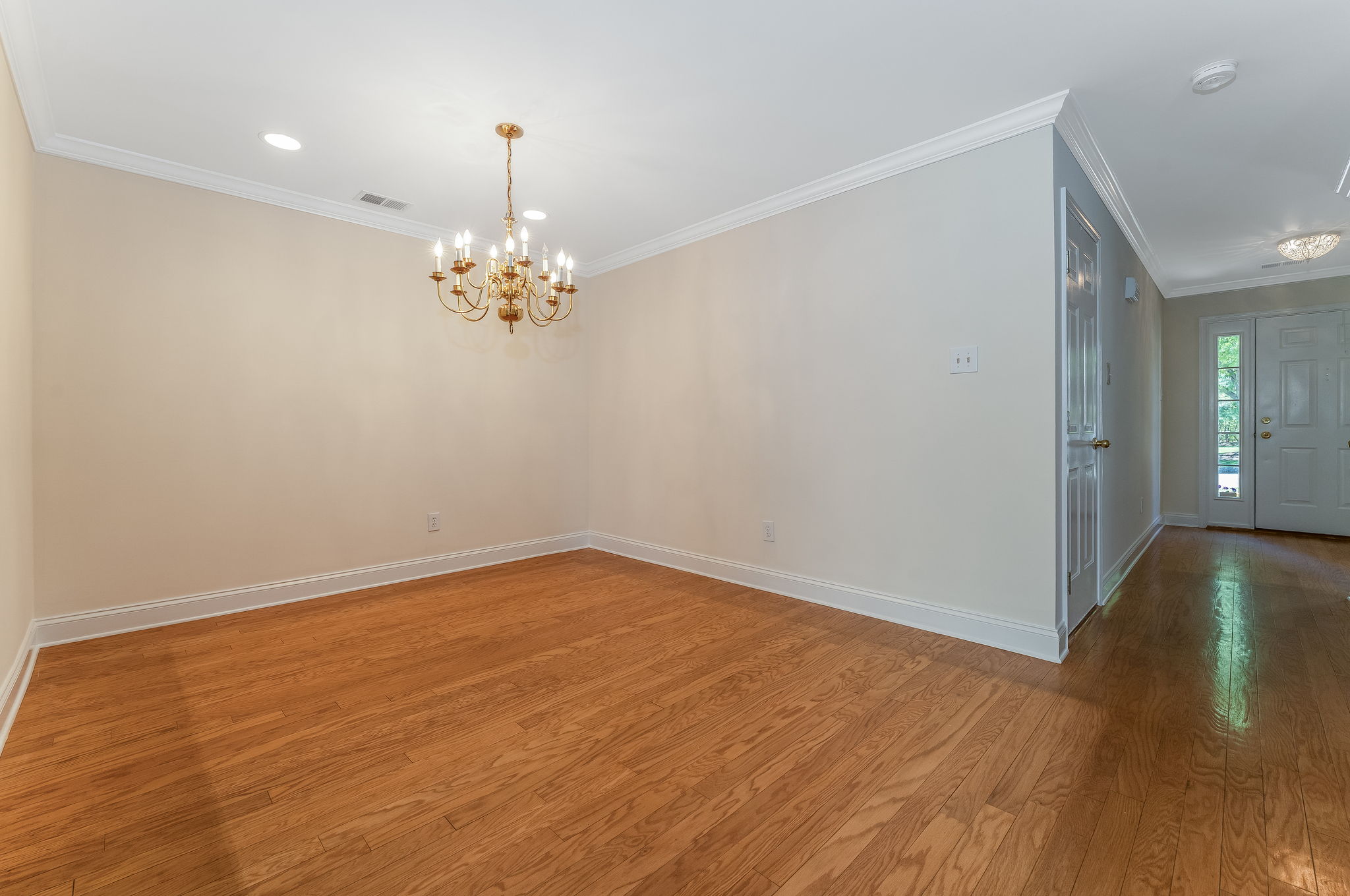 Hardwood flooring flows from the foyer into the dramatic two-story great room and formal dining room, highlighted by crown moulding.