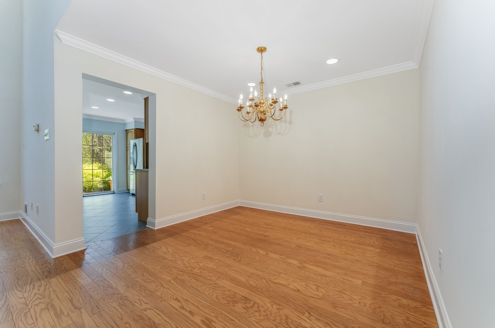 Hardwood flooring flows from the foyer into the dramatic two-story great room and formal dining room, highlighted by crown moulding.