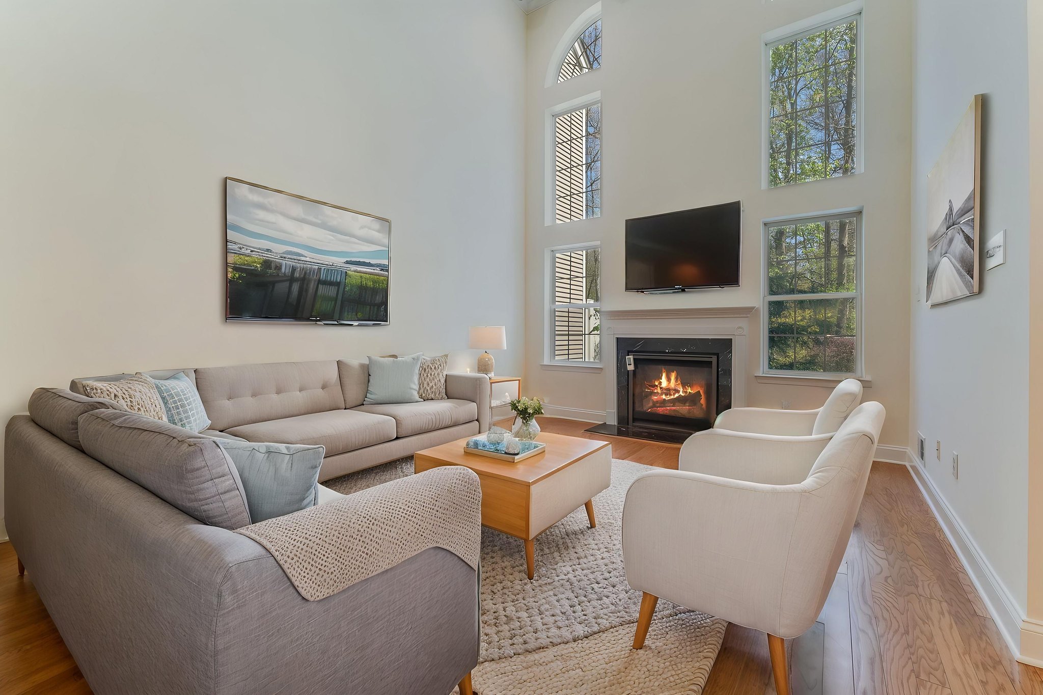 Virtually Staged-A gas fireplace with a classic mantel adds warmth and visual appeal to the great room. Oversized windows fill the open, airy floorplan with natural light.