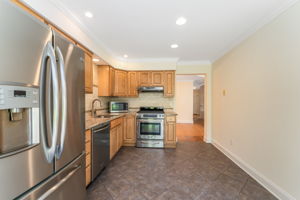 Breakfast nook sliders lead to a private fenced patio and a peaceful wooded backdrop,ideal for relaxing or entertaining.